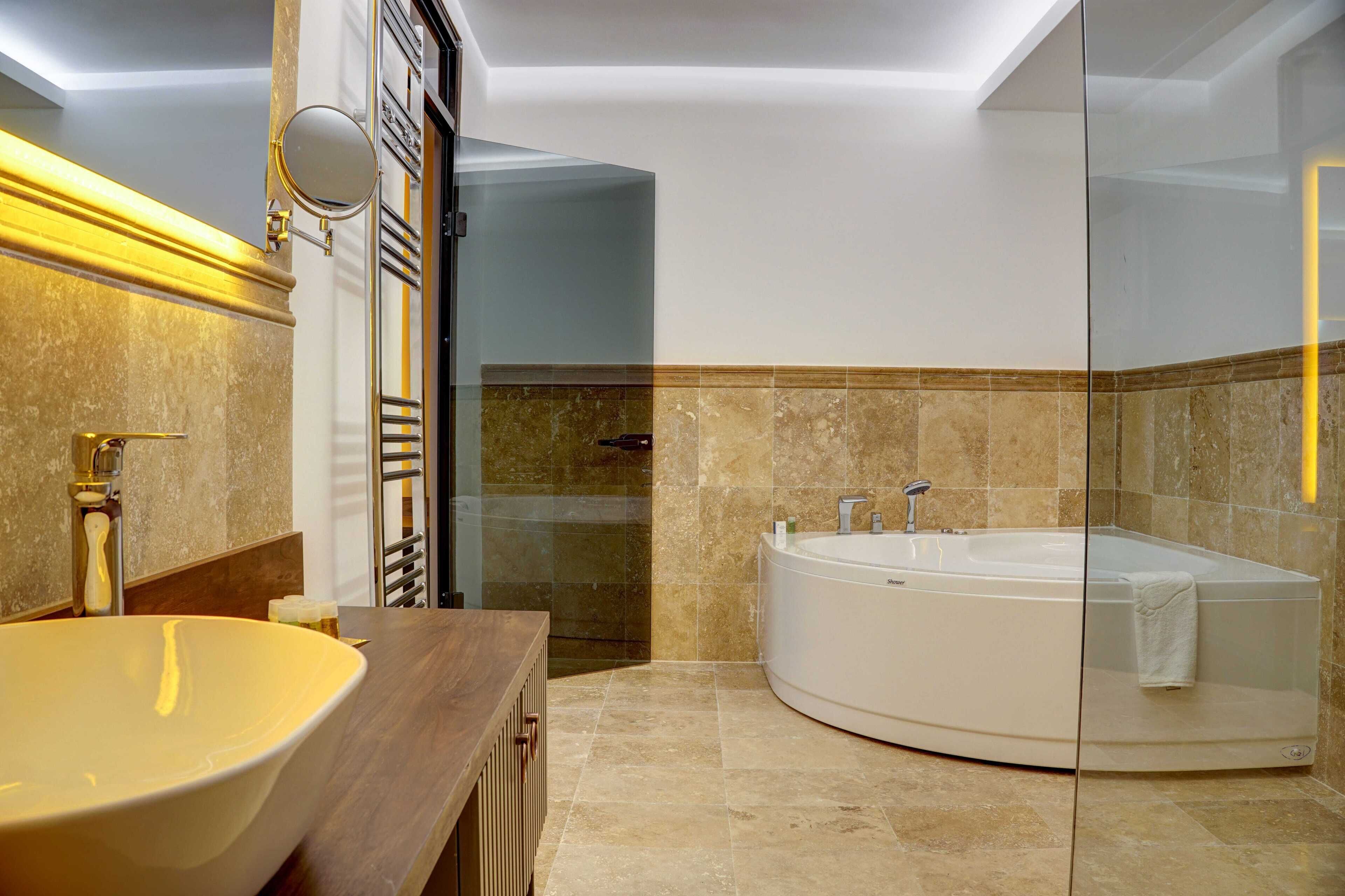 A modern bathroom with a freestanding bathtub, a large oval sink, and a glass shower enclosure.