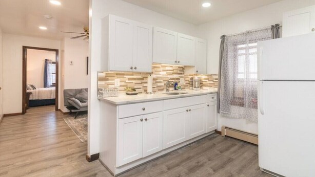 A modern kitchen with white cabinets, a wooden countertop, and a refrigerator. - Quiet Apt with Coffee Bar, 1/2 Mile to West Point! (Highland Falls)
