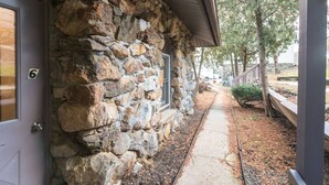 A stone building with a door labeled '6' and a pathway leading to a covered area. - Quiet Apt with Coffee Bar, 1/2 Mile to West Point! (Highland Falls)