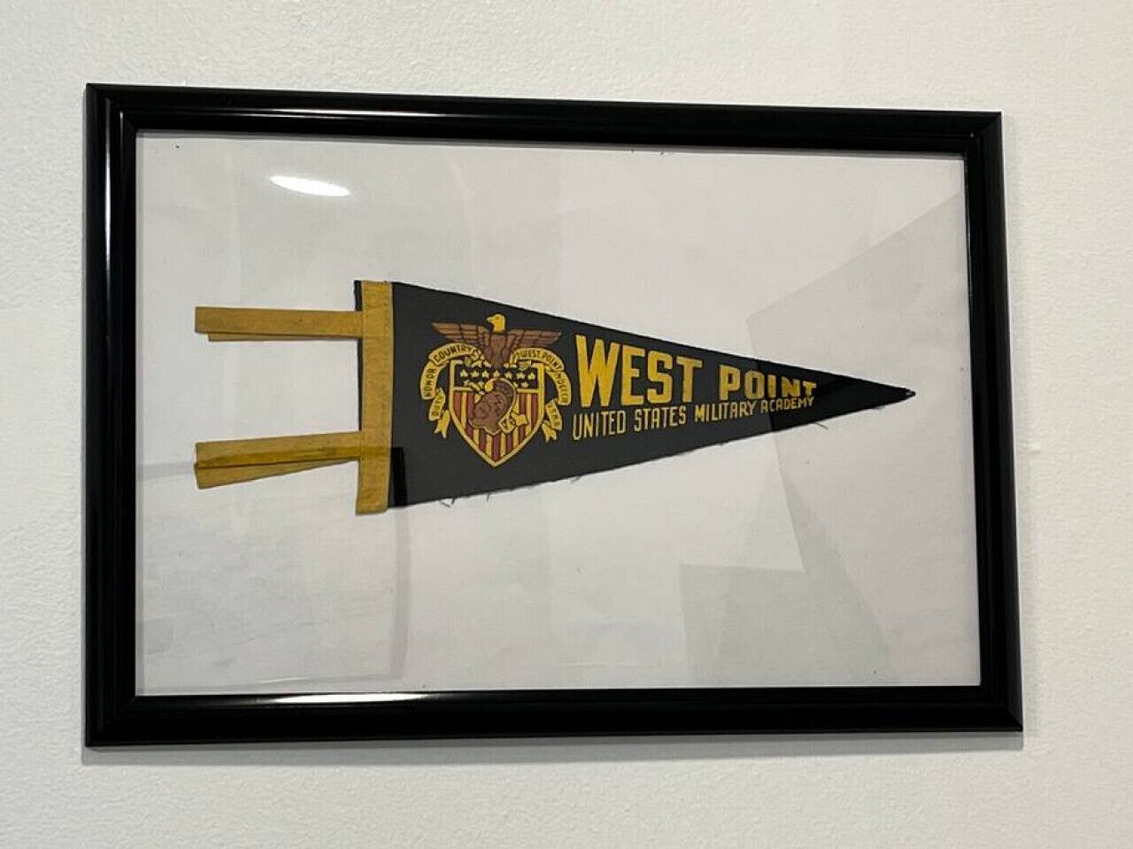A framed West Point United States Military Academy emblem.