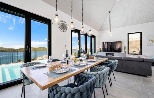 Enjoy meals in the dining area with a long table and comfortable seating.