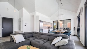 A modern living room with a large gray sectional sofa, a wooden coffee table, and a potted plant. - Stunning home in Zaboric (Zaboric)