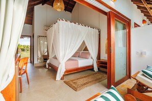 A bedroom with a canopy bed, wooden furniture, and a view of the outdoors. - MKNI Hotel - Makani Experience (Acaraú)