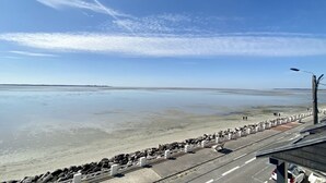 A coastal road with a view of the beach and the sea.