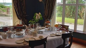 A table set for a meal with a view of the outdoors. - Ardsallagh Lodge (Tinnabinna)