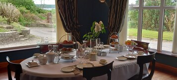 A table set for a meal with a view of the outdoors.