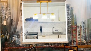 A modern kitchen with white cabinets, a stainless steel stove, and a marble backsplash. - Townhouse with a pool, arcade/gaming area and a massage chair! (City of Naga)