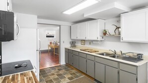 A modern kitchen with grey cabinets, a wooden countertop, and a tiled backsplash. - Charming 2 Bedroom Apartment Downtown In Vibrant Bozeman (Bozeman)