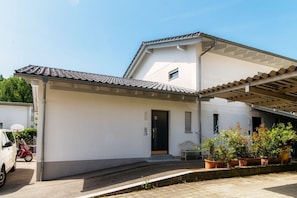 Guests can enjoy a patio with a bench and potted plants.