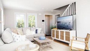 En moderne stue med sofa, fjernsyn og sofabord i flet.