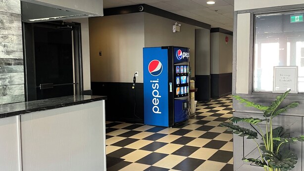 A lobby with a checkered floor, a Pepsi vending machine, and a security camera on the ceiling. - Nechako Valley Inn  (Vanderhoof)