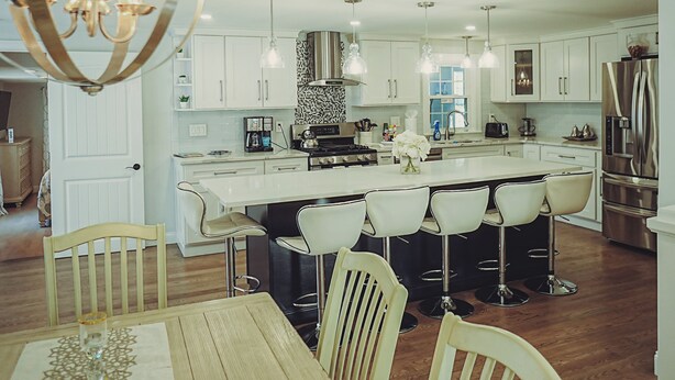 A modern kitchen with white cabinetry, a central island with bar stools, stainless steel appliances, and pendant lighting. - Beach nearby Pool/HotSpa Firepit LGbackyard (Barnstable)