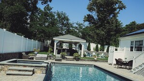 A swimming pool with a pergola and outdoor seating area. - Beach nearby Pool/HotSpa Firepit LGbackyard (Barnstable)