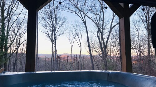 Great sunset view, hot tub, game room, big fire pit and new large fenced yard!