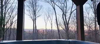 Great sunset view, hot tub, game room, big fire pit and new large fenced yard!