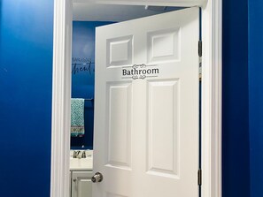 A white door with a sign reading "Bathroom 50" above it.