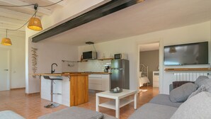 A modern apartment with a kitchen, dining area, and living room.