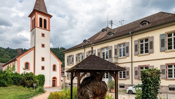 A church with a bell tower and a building with shuttered windows. - Holiday Apartment "Hach" with Private Terrace & Wi-Fi (Sulzburg)