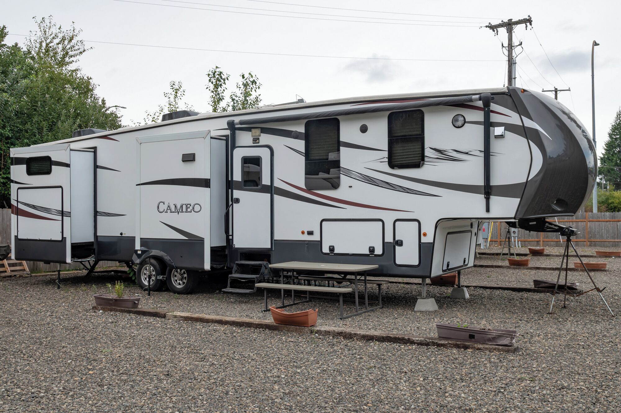 A recreational vehicle with a sliding door, a small kitchen area, and a sleeping berth.