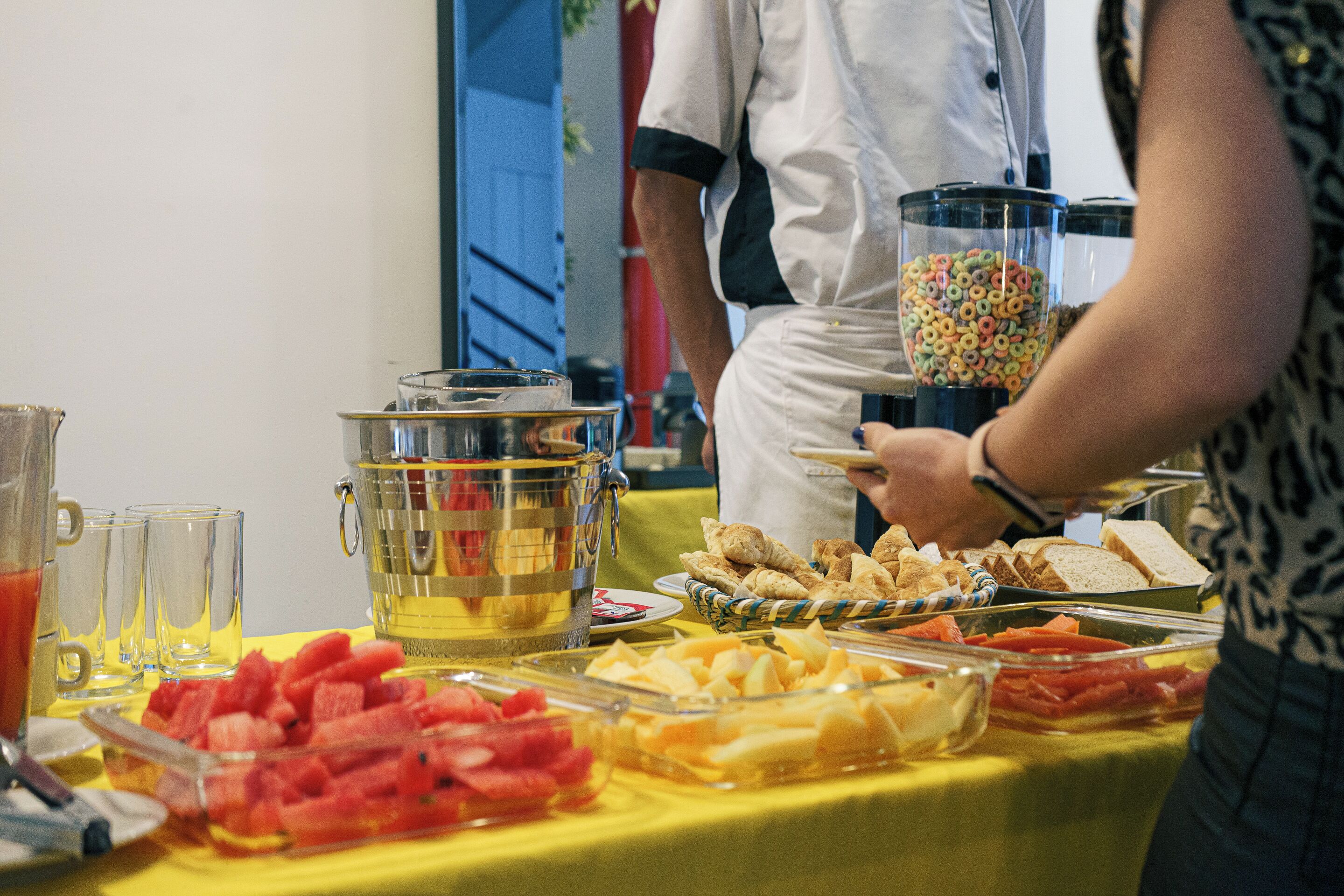 A buffet table with various food items and a punch bowl.