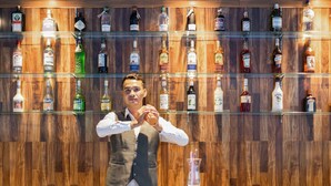 A bar with multiple shelves of liquor bottles. - Munich Hotel (Sihanoukville)