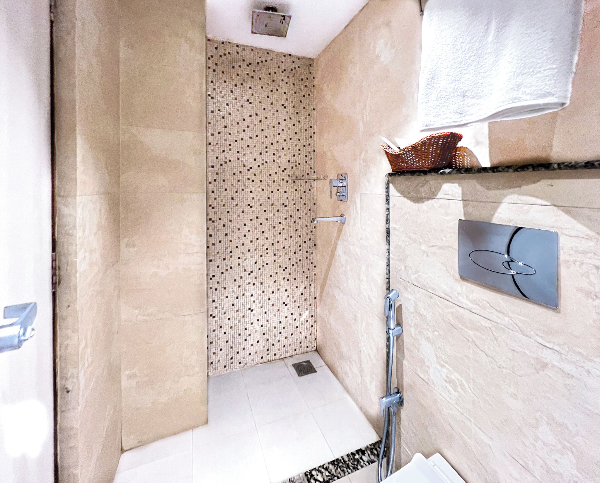 A bathroom with a shower, a towel rack, and a mirror.