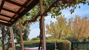 A wooden deck with a white bathtub and a stone fountain. - Murray River Spa Retreat (Echuca)