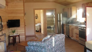 A cozy cabin interior with a living area, a kitchen, and a bedroom. - Dreamcatcher Bungalow 20min to W.Glacier, between Glacier&Airport (Columbia Falls)