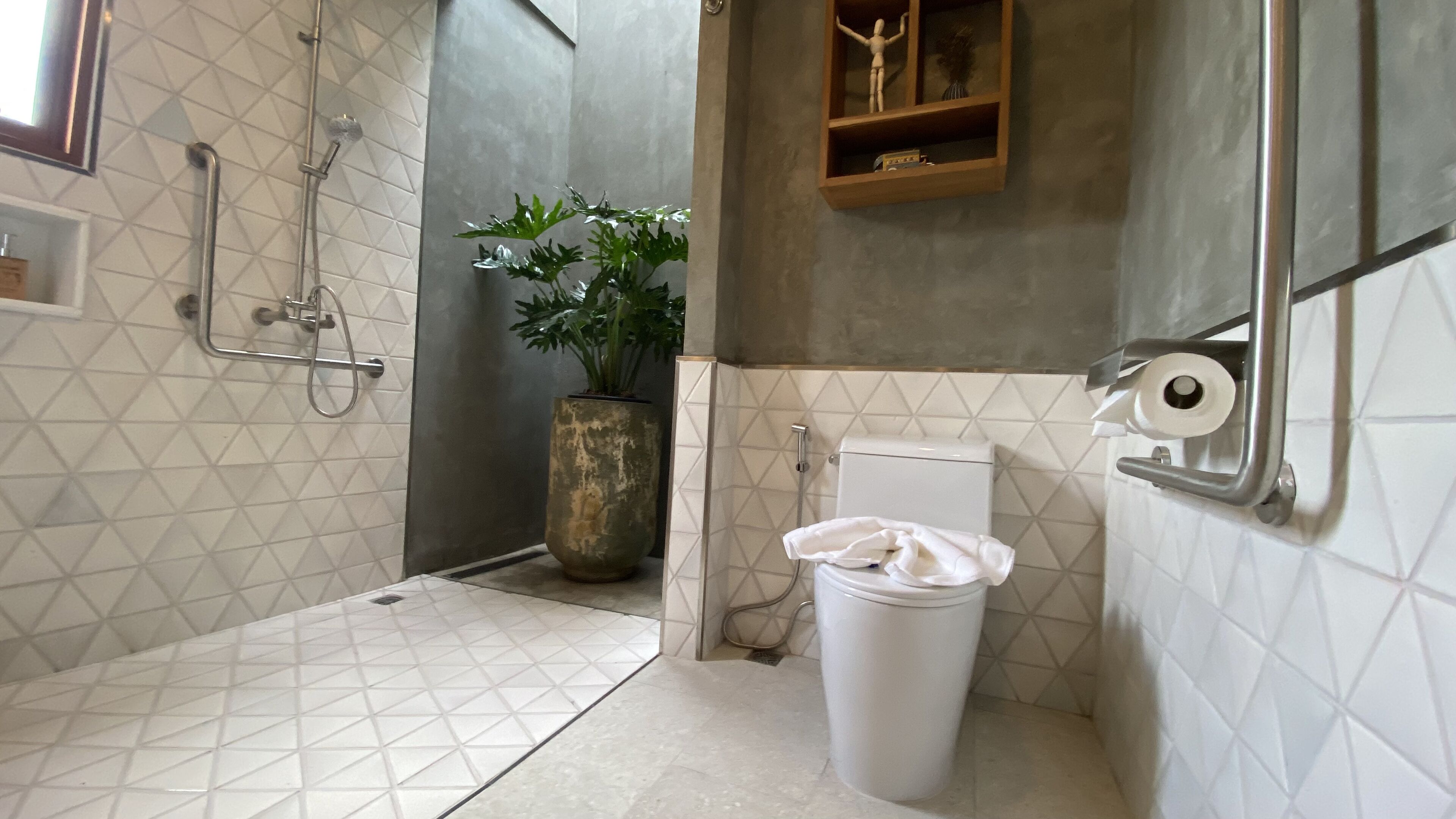A bathroom with a shower, toilet, and a sink.