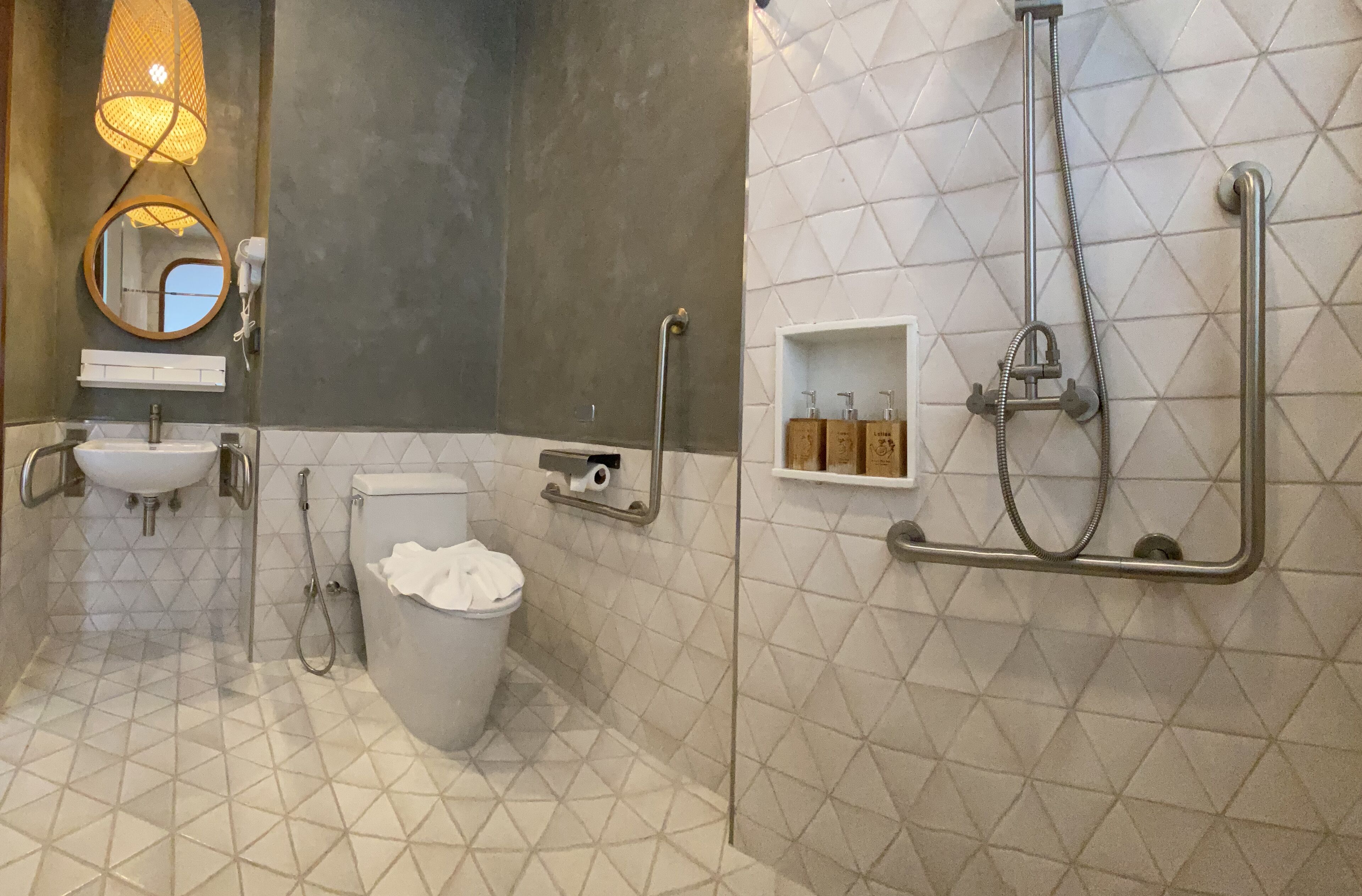 A modern bathroom with a toilet, sink, and shower.