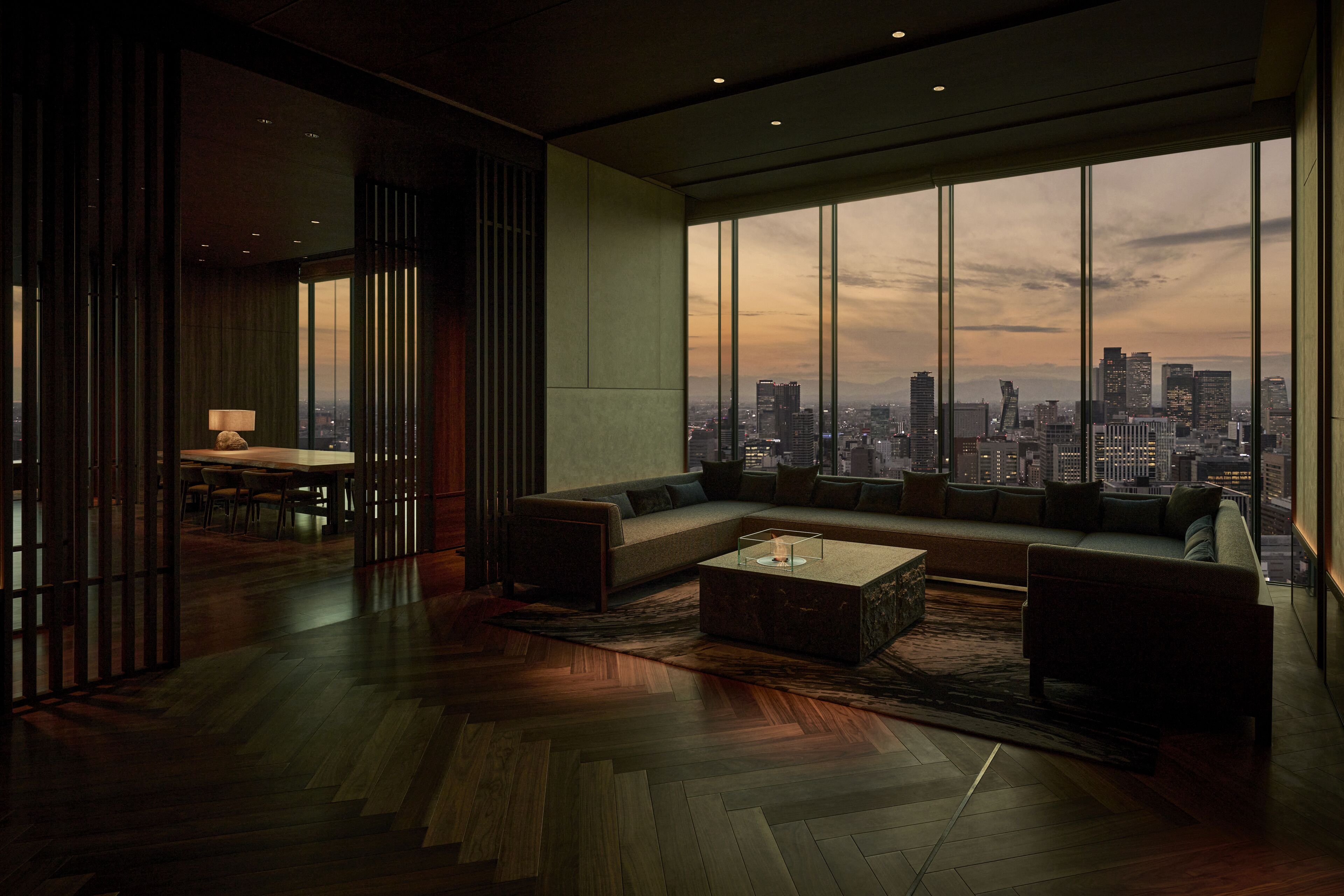A modern living room with a large window, a sofa, a coffee table, and a dining area.