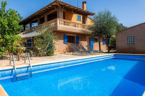 A two-story building with a swimming pool, a balcony, and a view of the surrounding area. - Country House "Sa Plana" with Private Pool, 2 Private Terraces, and Wi-Fi (Son Servera)