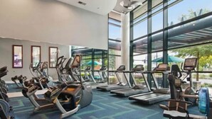 A gym with treadmills, elliptical machines, and stationary bikes. - The Heart of the city (Atlanta)