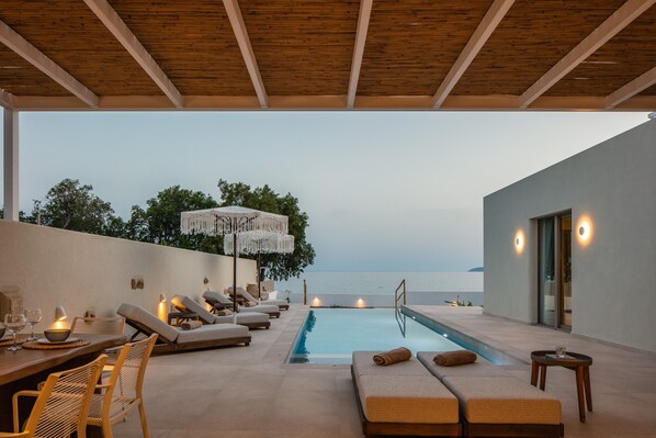 A heated pool, sun loungers