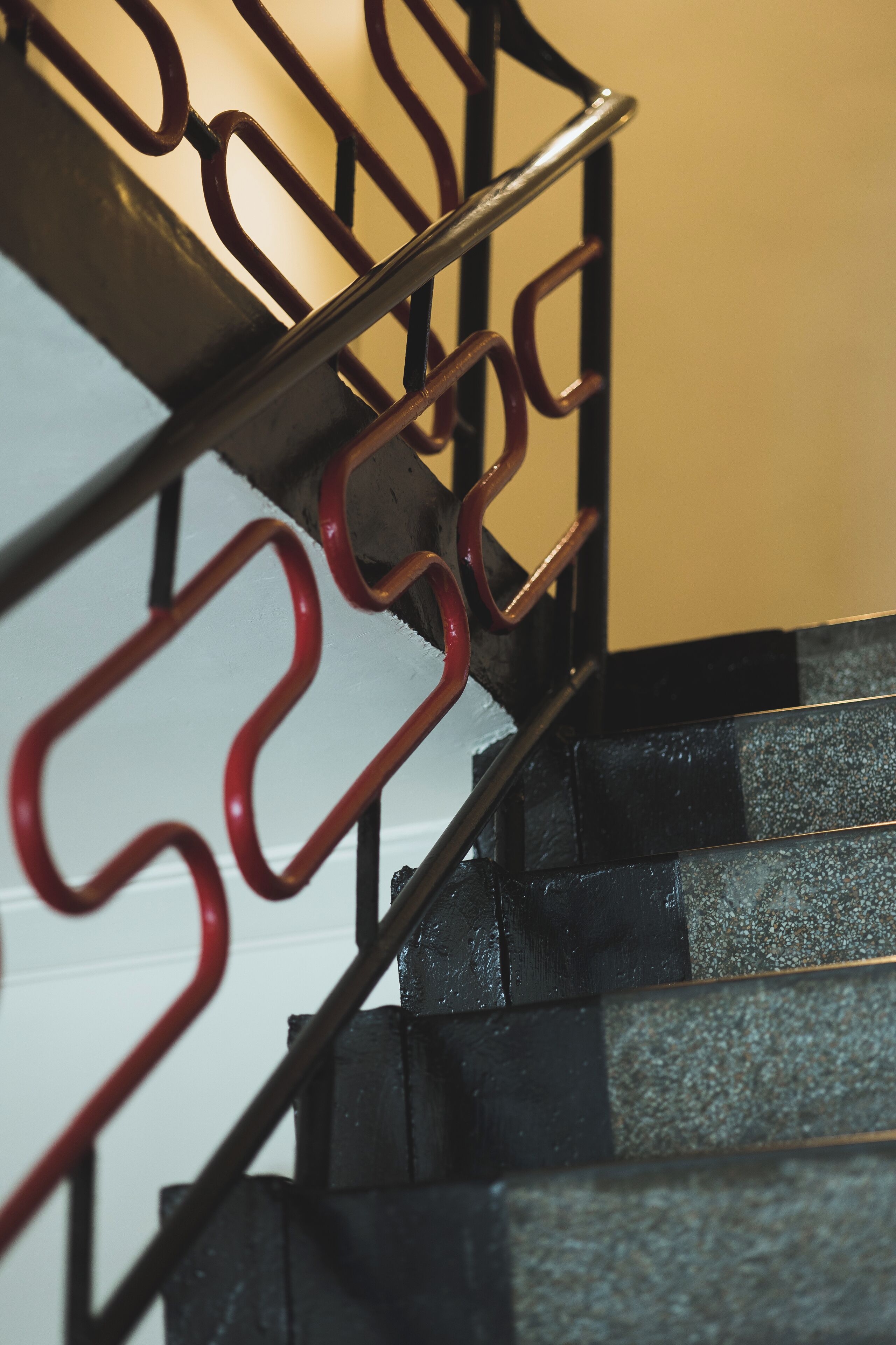 A close-up of a metal staircase with a handrail and steps.