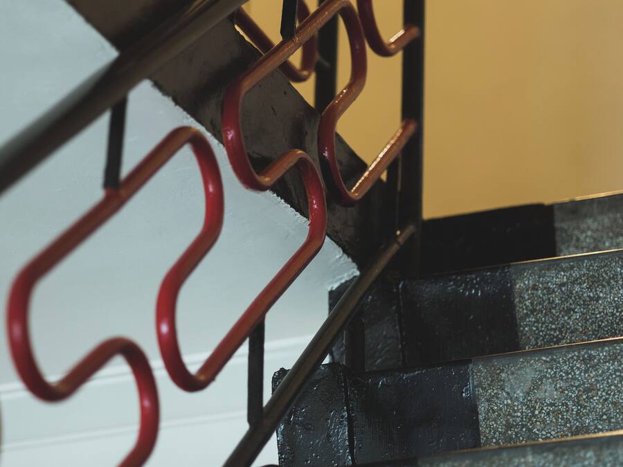 A close-up of a metal staircase with a handrail and steps.
