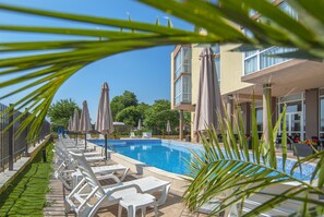 Seasonal outdoor pool, open 9:00 AM to 9:00 PM, pool umbrellas