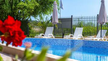 Seasonal outdoor pool, open 9:00 AM to 9:00 PM, pool umbrellas