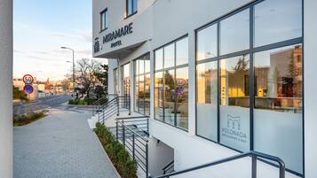 Experience the sleek design of Miramare Hotel, where large windows offer stunning views of the surrounding area.