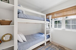 A bunk bed room with a window, a mirror, and a rug. - Pro Designer Cottage, 4/10 Mile to New Circle Beach (Lakeside)