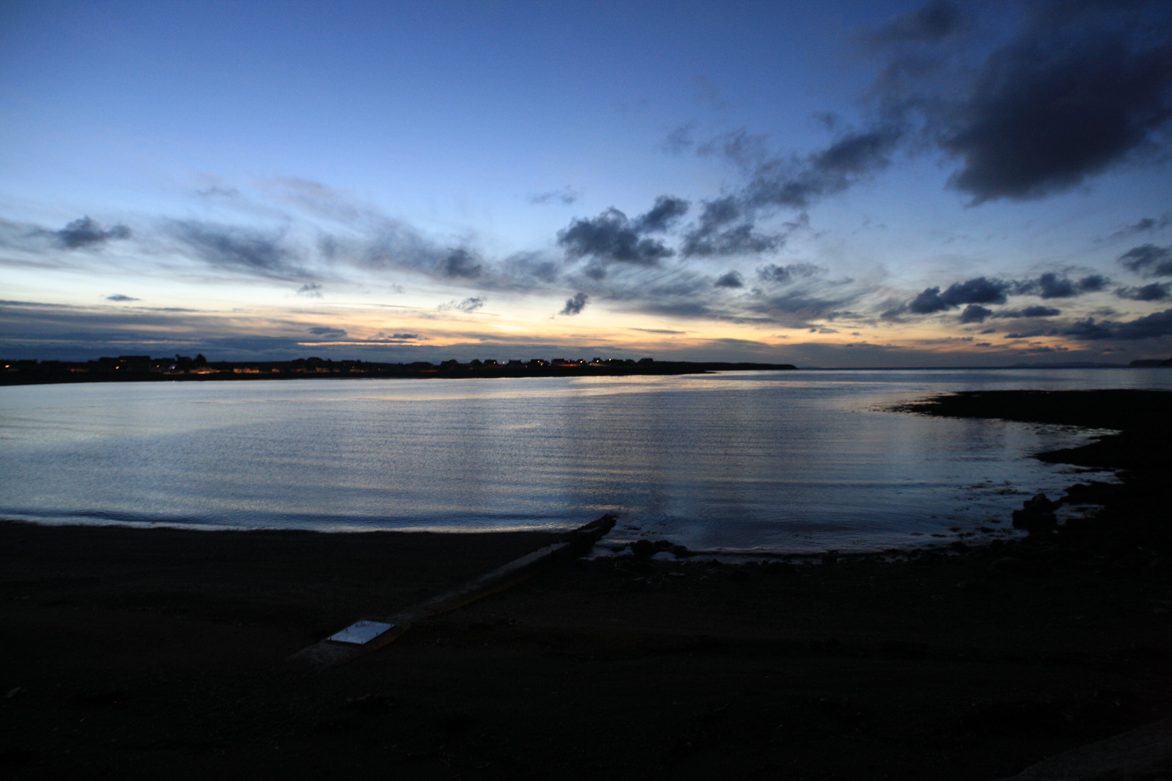 A calm body of water reflecting the sky.