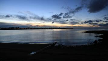 A calm body of water reflecting the sky.