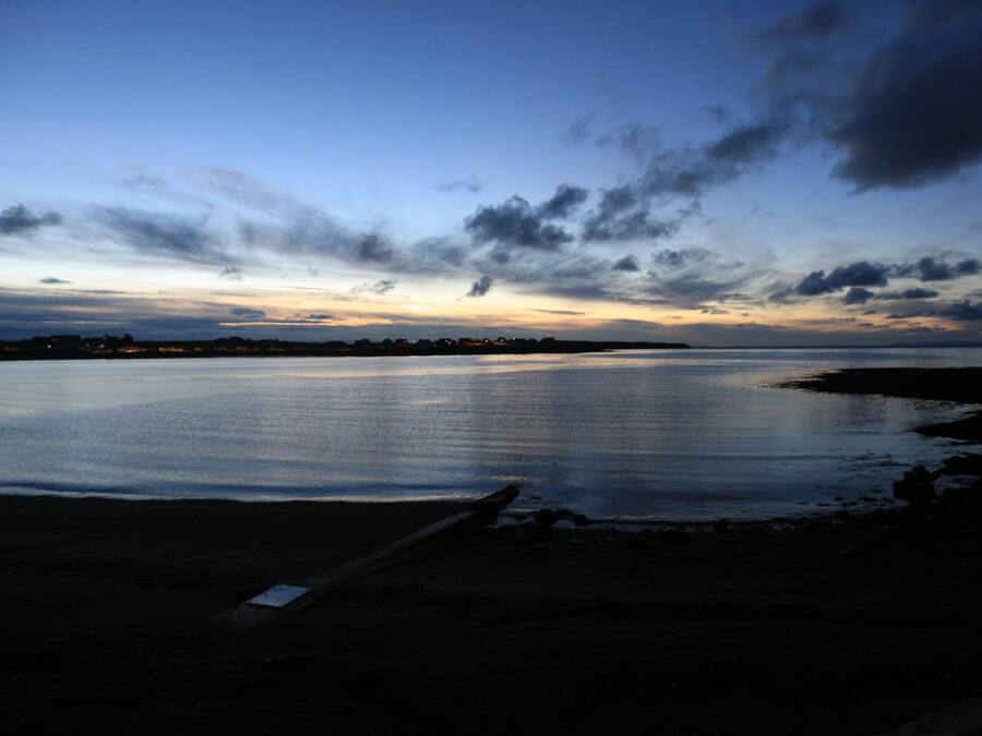 A calm body of water reflecting the sky.