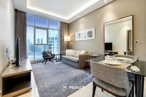 Enjoy a city view from the large window, relax on the comfortable sofa, and dine at the table for two.