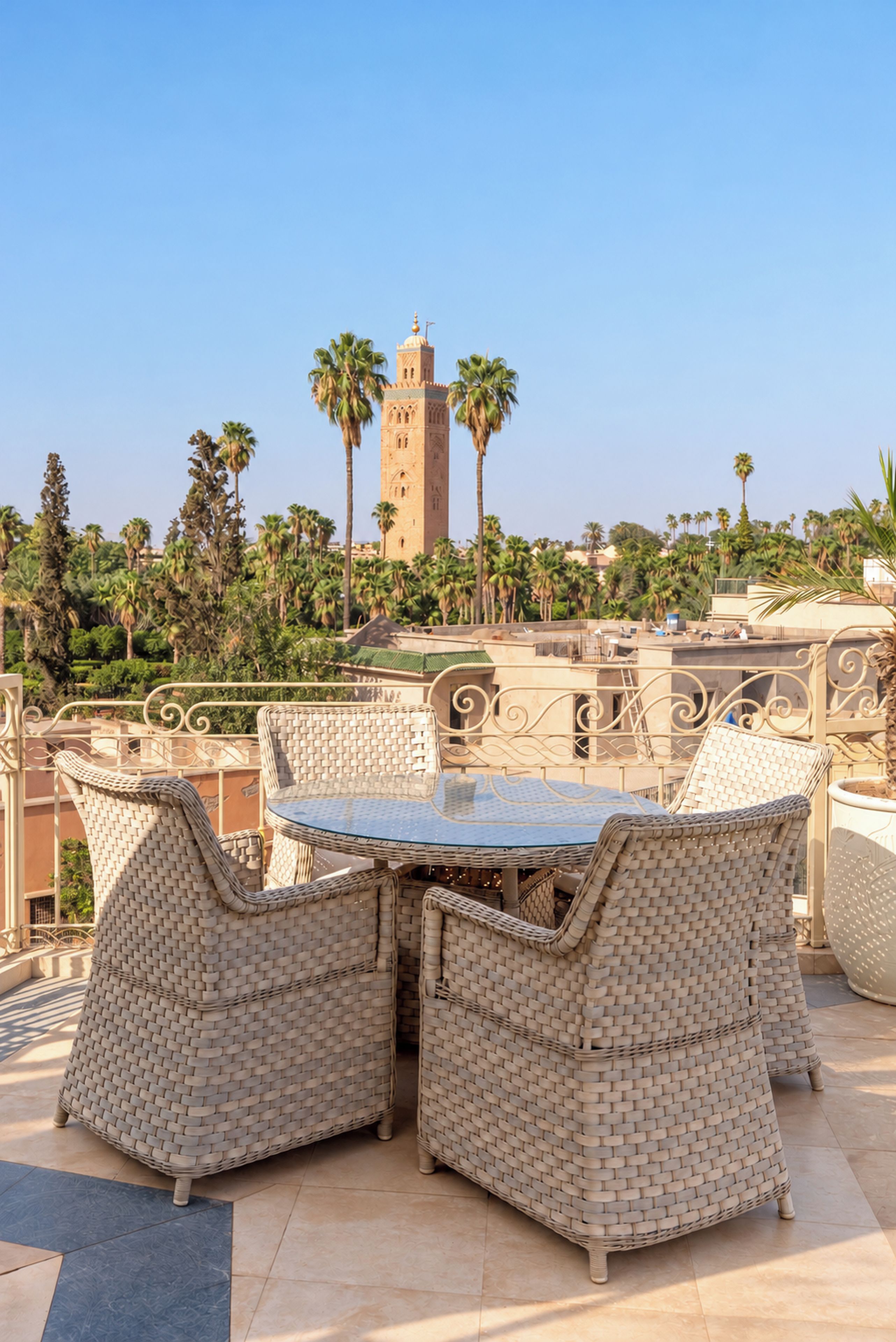 A terrace with wicker furniture and a view of a tall tower.