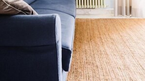 A living room with a blue sofa, a bookshelf, and a radiator. - STANDARD APARTMENT (Roma)