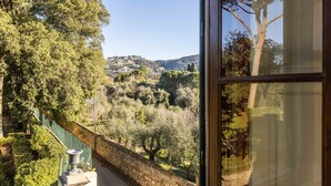 A view from a window overlooking a hillside with trees and a distant town. - Villa in Florence with 5 bedrooms sleeps 10 (Florence)