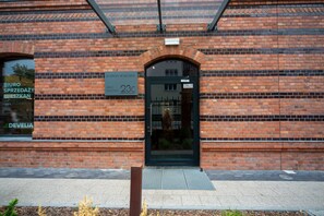 Step into the historic Bastion Walowa 23C, a charming brick building with a distinctive entrance.