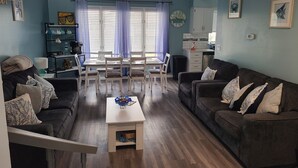 A living room with a dining area, a sofa, a coffee table, and a kitchen in the background. - Family Fun!! 2 Blocks to Famous Boardwalk & Beach. 3Br/2Fb. 4 Adults + Kids (Seaside Heights)