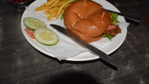 A plate with a sandwich, fries, and sliced cucumbers. - Hotel Namaskar (Kathmandu)